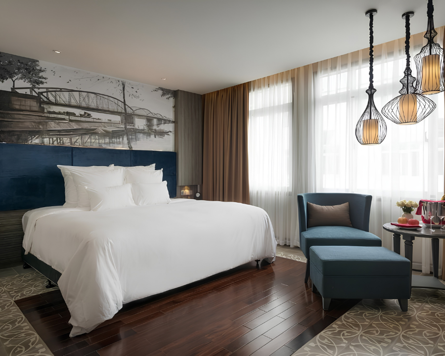 Paradise Suites guest room with king bed and artwork.