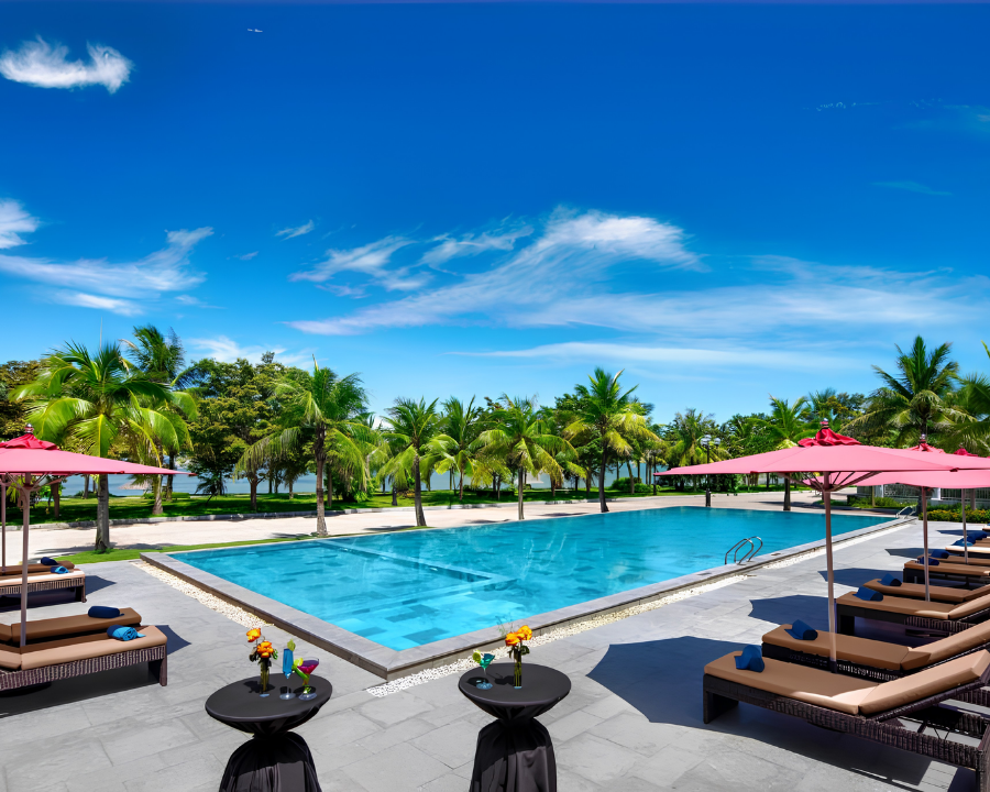 Paradise Suites poolside with sea view and palms.