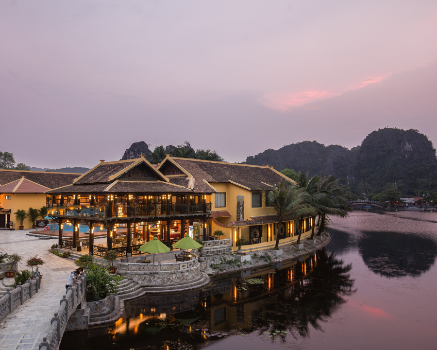 Emeralda Resort lakeside pavilion at sunset in Ninh Binh.