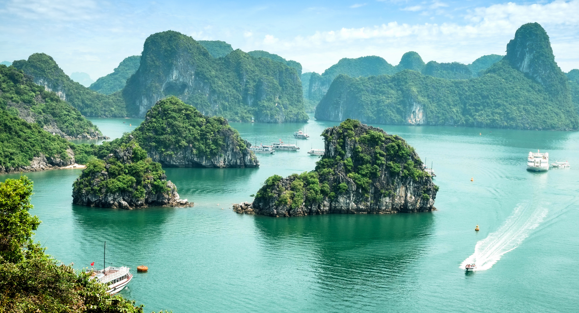 Ha Long Bay panorama with emerald water and limestone karsts.